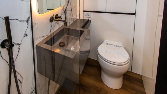 The Sunreef 60 Mr. Si bathroom features black fixtures, wood flooring and marble accents for a sleek, smart look.