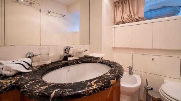 Available for charter in Athens the 4 cabin 10 guest Falcon 86 Estia Poseidon motor yacht features a private bathroom wi