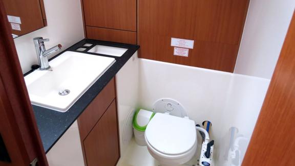 The bathroom of sailing yacht Almina features a modern sink and toilet.