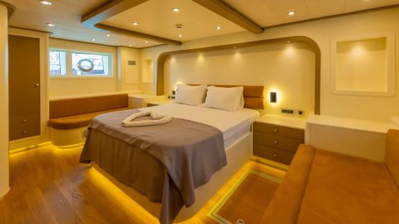 The modern bedroom of the luxury trawler Lycian Dream in Fethiye features a comfortable bed and stylish design.