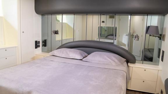 The bedroom on Alfa F yacht features a comfortable bed and stylish interior design.