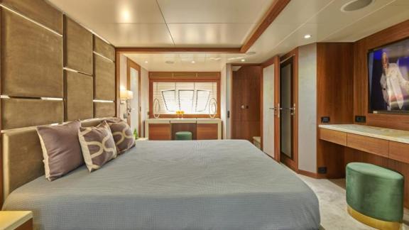 Spacious and stylish master cabin on motor yacht La Fenice with large bed and TV.