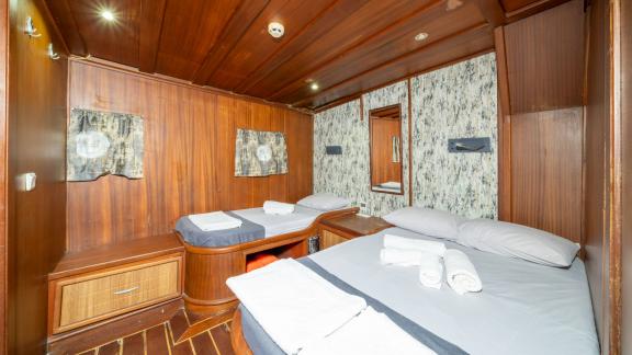 Enjoy comfort in the spacious bedroom of Gulet S Nur 1 with two comfortable beds and elegant decor.