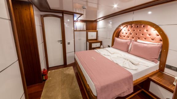 The cabin features a cozy bed, elegant interior, and practical storage space for your comfort.