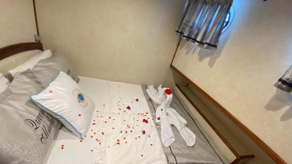 Lovingly decorated cabin on the Queen Almila gulet with flower petals and towel art.