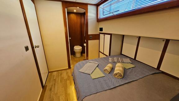 Comfortable guest cabin on Gulet Arni with ensuite bathroom and modern design.