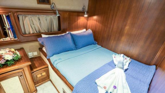 Intimate cabin with a comfortable double bed on a Gulet in Fethiye, ideal for relaxing nights.