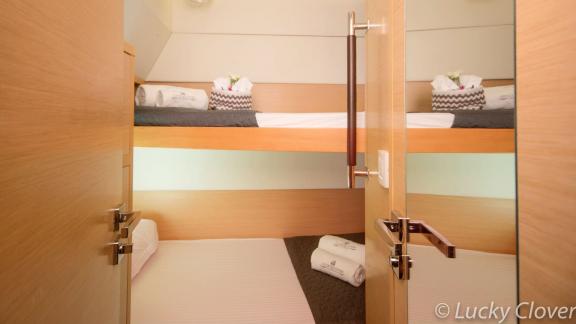 The cabin on Catamaran Lucky Clover features comfortable bunk beds, perfect for families or groups.