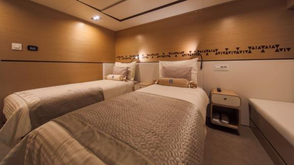 Comfortable twin bedroom on Omnia with modern design.