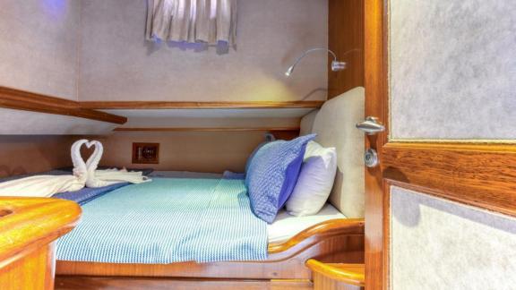 Small yet comfortable cabin with a cozy bed on a Gulet in Fethiye, ideal for relaxing nights.