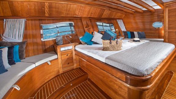 A spacious and comfortable cabin on board the Flas VII, with large windows and stylish furnishings.