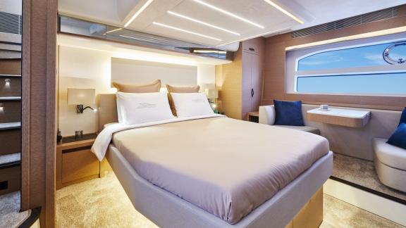 The master bedroom of the motor yacht Shaft features a large bed and modern decor.