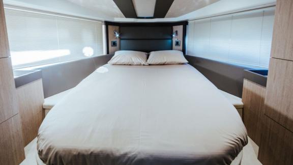 The cabin with a large bed on motor yacht Brown Sugar offers comfortable accommodation.