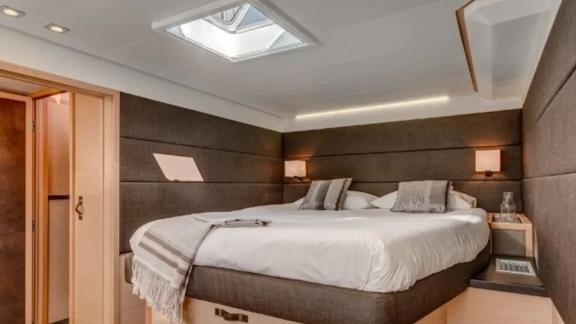 Luxurious master cabin with a soft king-size bed and natural light on Lagoon 630 Pearly Gates.