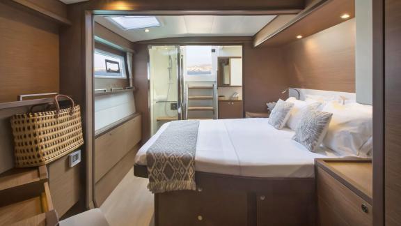 The stylishly furnished cabin of the Lagoon 560 in Athens features a large bed, ample storage, and direct access to the 