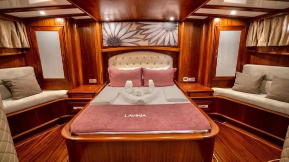 Enjoy comfort and elegance in the luxurious cabin of Gulet Lavinia with fine wood decor.