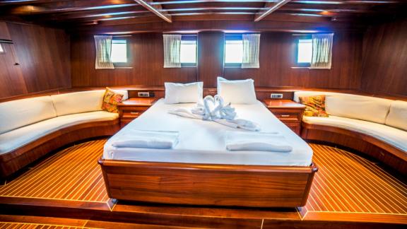 Elegant and spacious cabin equipped with a large bed and comfortable seating.