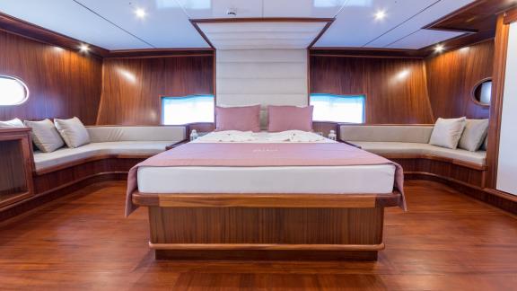 The spacious master cabin offers a comfortable bed and elegant seating areas for restful nights.