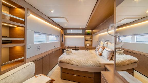 Spacious and elegantly designed cabin with a large bed in the catamaran Princess S