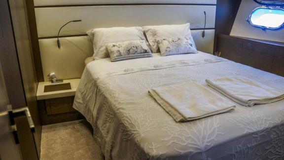 Master cabin of Kuum motor yacht with double bed and modern design.