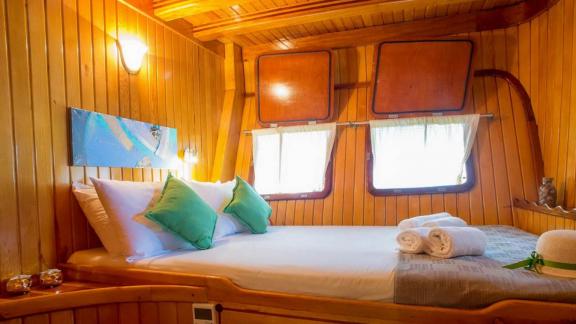 Warm, inviting cabin with a double bed on a Gulet yacht. Relax in luxurious comfort.