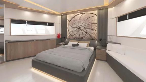 The master cabin of trawler Lavin features a large bed, modern decor, and elegant lighting.