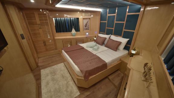 The luxurious bedroom of the trawler Compass offers elegant design and a comfortable bed.