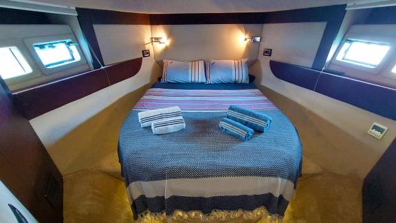 The luxurious guest cabin of motor yacht Germanor offers peaceful accommodation with a comfortable bed and modern decor.