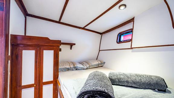 Comfortable cabin of the 22 meter Gulet Castiel with a cozy double bed and charming interior.