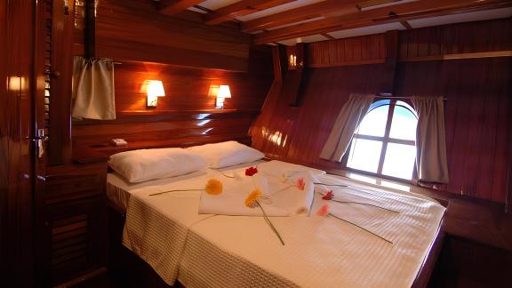 Comfortable cabin on the Sunworld 8 with a double bed and romantic lighting.