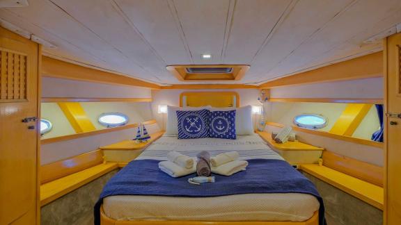 The cabin with a large bed on motor yacht Ada Kuzey offers a comfortable sleeping area.