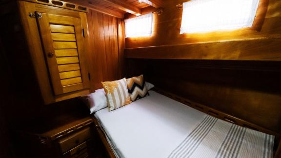 Comfortable double cabin on Gulet Pronto White with warm wood decor and cozy lighting.