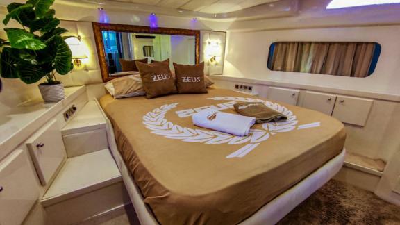 The bedroom of motor yacht Zeus 1 offers comfortable accommodation with luxurious decor.