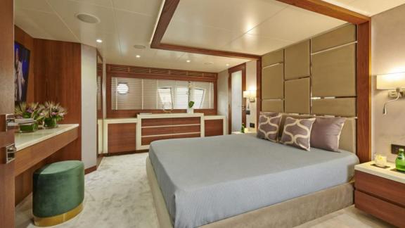 Stylish guest cabin on motor yacht La Fenice with large bed and modern interior.