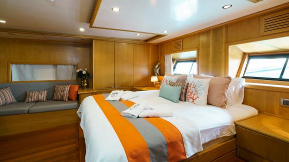 Comfortable cabin on the Gulet Happy Hours with large bed and stylish furnishings.