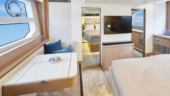 The master bedroom of the motor yacht Shaft features a large bed, seating area, and modern decor.