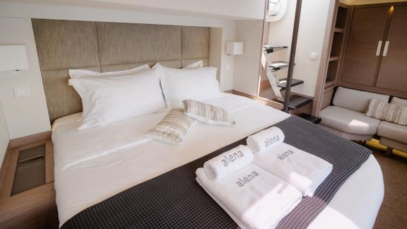 Luxurious cabin with large double bed and modern decor on a catamaran.