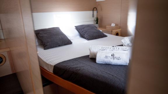 Inviting bedroom on Catamaran Lucky Clover with stylish pillows and luxurious bedding.