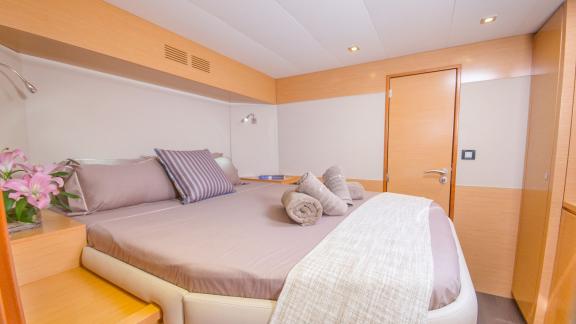 The cabin of catamaran High Five offers modern decor and a comfortable bed.