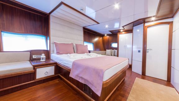 The master cabin features a luxurious bed, stylish furniture, and ample space for relaxation.