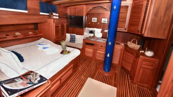 The cabin of gulet Barka offers a large bed, wooden cabinets, and modern amenities for a comfortable stay.