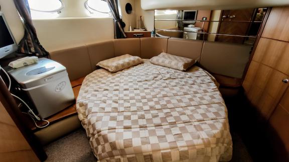 The bedroom of motor yacht Ela offers a spacious and comfortable sleeping area.