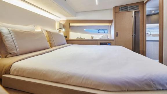 The master bedroom of the motor yacht Shaft features a large bed and modern decor with elegant design.