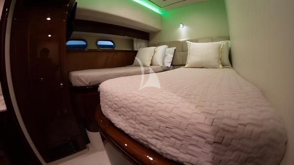 The cabin of the Hasard yacht features two comfortable single beds and modern decor.