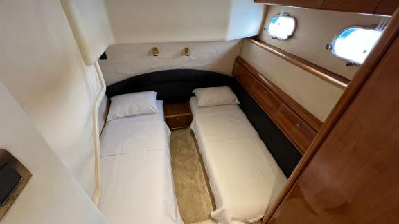 Twin bedroom on motor yacht Sky 22 offers comfort and coziness.