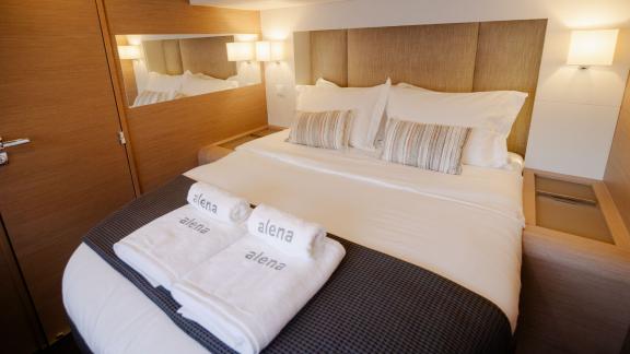 Cozy cabin with double bed and stylish lighting on a catamaran.