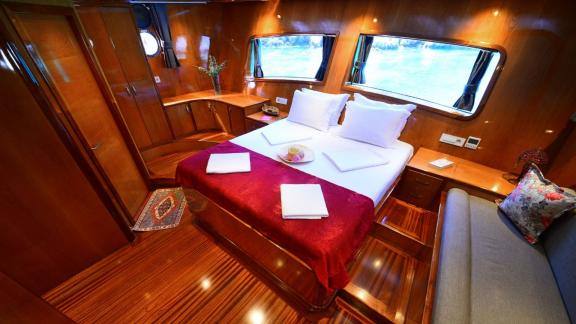 Bright and inviting guest cabin on the Gulet Maya with large bed.