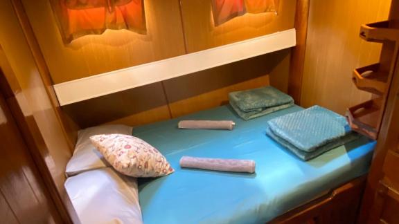 Comfortable cabin with double bed and soft lighting on Gulet Avuncan, perfect for a relaxing night.