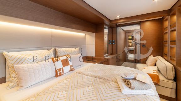 High-end cabin with a large bed and elegant wood details in the catamaran Princess S