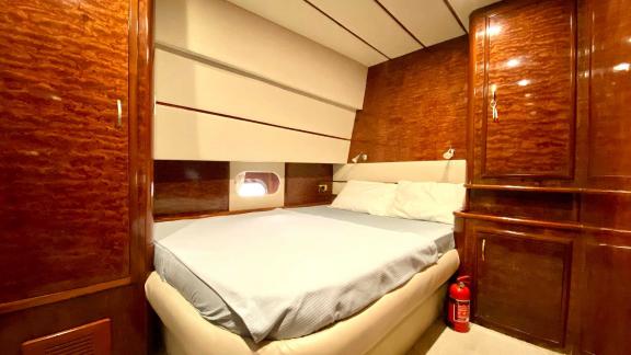 The stylish bedroom on Vedo B yacht is equipped with a comfortable bed and ample closet space.